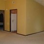 Livinig room looking at dining room on left. Left door is master bed, other too entrances go to kitchen. Front door behind fireplace.